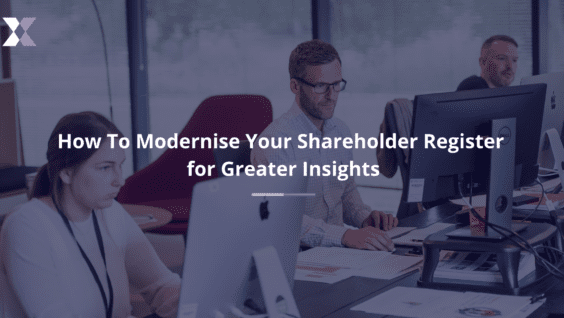 Three professionals working at shared desk