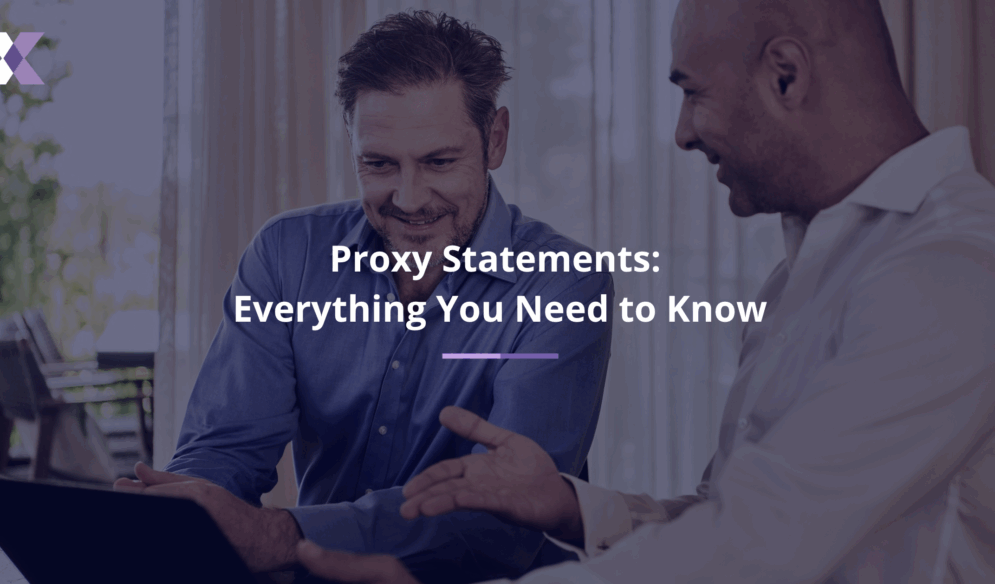 Two smiling men view a laptop screen to represent proxy statements: everything you need to know