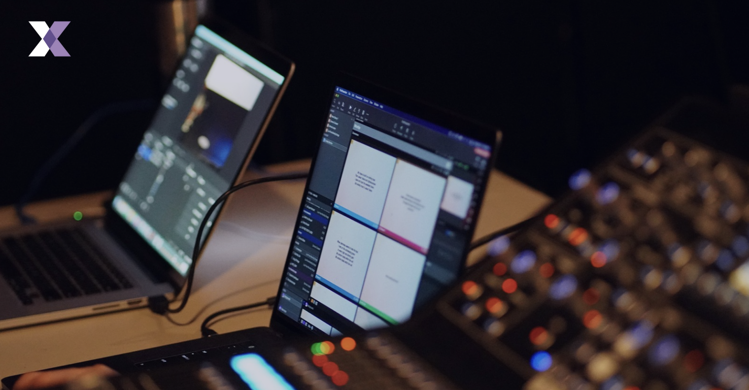 two laptops and a connection unit to represent pre-meeting technology set up
